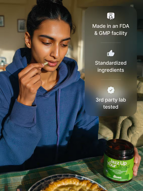 Person eating a snack with a green container labeled 'Jazz Up Your Life' on a table.