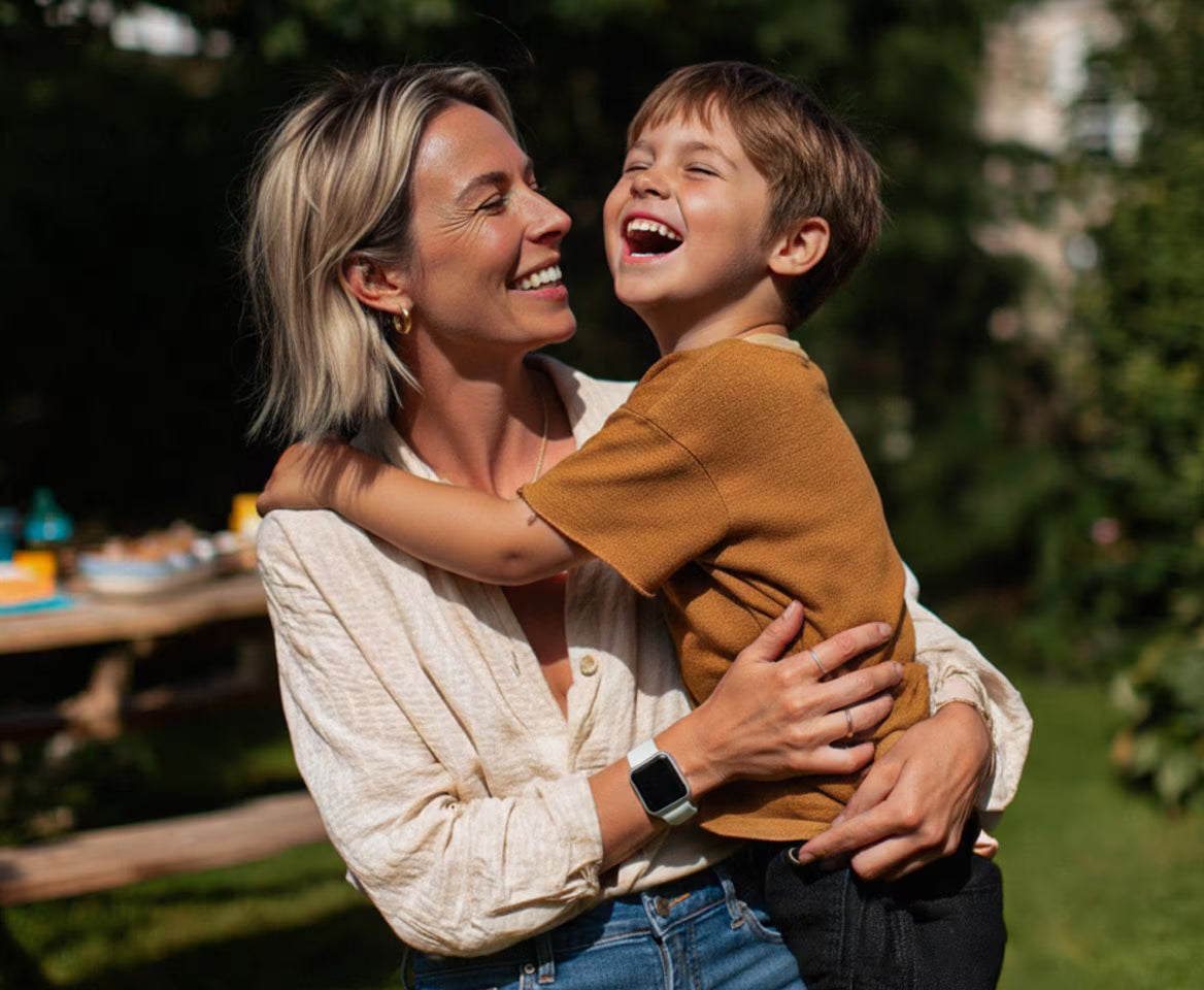 Woman and child laughing together outdoors